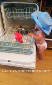 little chef loading dishwasher