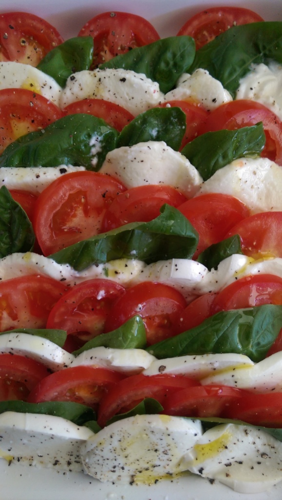 Tomatoes, basil, and buffalo mozzarella drizzled with olive oil and salt and Pepper.  Simple, yet perfect.  